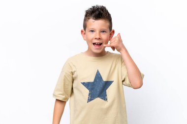 Little caucasian boy isolated on white background making phone gesture. Call me back sign