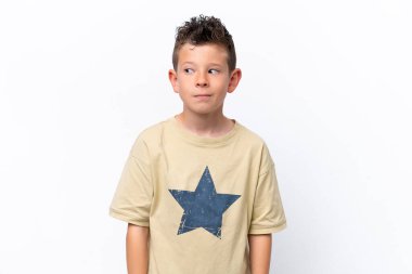 Little caucasian boy isolated on white background making doubts gesture looking side