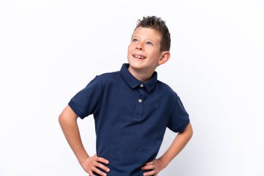 Little caucasian boy isolated on white background posing with arms at hip and smiling