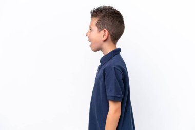 Little caucasian boy isolated on white background laughing in lateral position