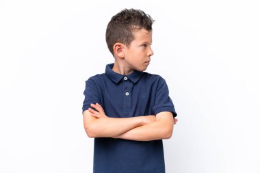 Little caucasian boy isolated on white background keeping the arms crossed