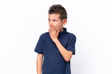 Little caucasian boy isolated on white background whispering something with surprise gesture while looking to the side