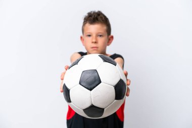 Boy playing football over isolated white wall