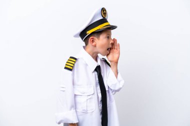 Little airplane pilot boy isolated on white background shouting with mouth wide open to the side