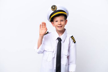 Little airplane pilot boy isolated on white background saluting with hand with happy expression