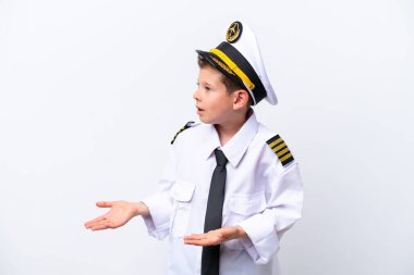 Little airplane pilot boy isolated on white background with surprise expression while looking side