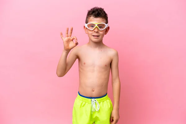 Little Caucasian Boy Wearing Diving Goggles Isolated Pink Background Showing —  Fotos de Stock