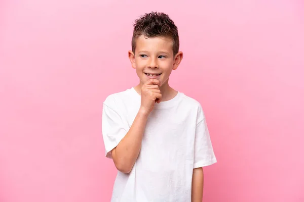 Little Caucasian Boy Isolated Pink Background Looking Side Smiling — Fotografia de Stock