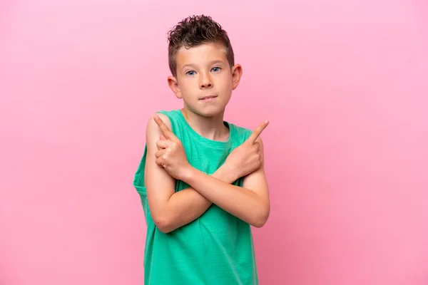 Little Caucasian Boy Isolated Pink Background Pointing Laterals Having Doubts — Fotografia de Stock