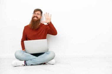 Young reddish caucasian man with laptop isolated on white background counting five with fingers