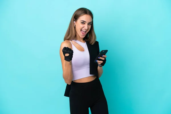 Young Sport Woman Isolated Blue Background Phone Victory Position — Zdjęcie stockowe