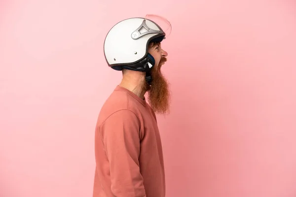 Young Reddish Caucasian Man Motorcycle Helmet Isolated Pink Background Laughing — Zdjęcie stockowe