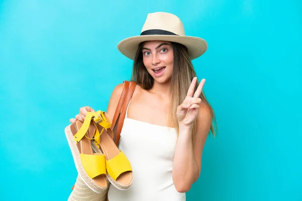 Young Woman Swimsuit Holding Summer Sandals Isolated Blue Background Smiling — Fotografia de Stock