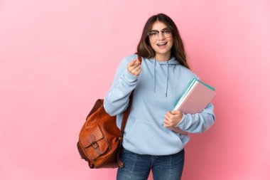 Pembe arka planda izole genç bayan şaşırmış ve ön tarafı işaret ediyor.