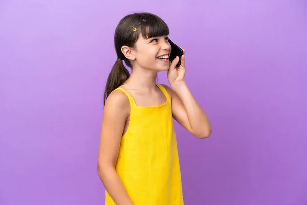 Little Caucasian Kid Isolated Purple Background Keeping Conversation Mobile Phone — Fotografia de Stock