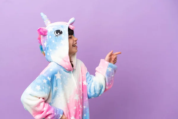 Little Kid Wearing Unicorn Pajama Isolated Purple Background Pointing Finger — Zdjęcie stockowe