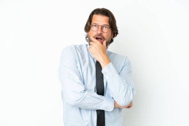Senior dutch business man isolated on white background surprised and shocked while looking right