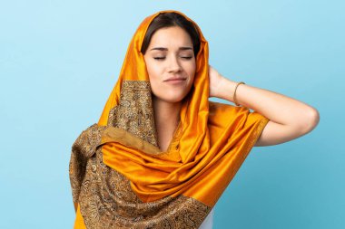 Young Moroccan woman with traditional costume isolated on blue background with neckache