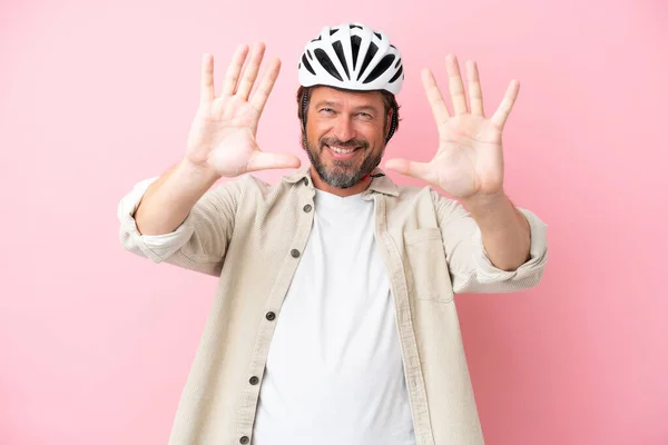 Senior Dutch Man Bike Helmet Isolated Pink Background Counting Ten — 图库照片