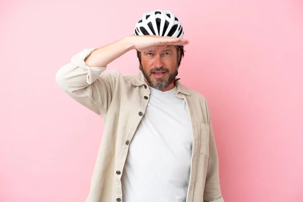 Senior Dutch Man Bike Helmet Isolated Pink Background Looking Far — Stockfoto