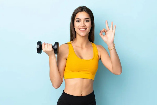 Young Caucasian Woman Making Weightlifting Isolated Blue Background Showing Sign — Foto Stock