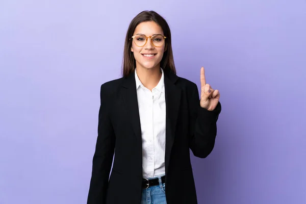 Business Woman Isolated Purple Background Showing Lifting Finger Sign Best — ストック写真