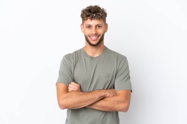 Young caucasian handsome man isolated on white background keeping the arms crossed in frontal position