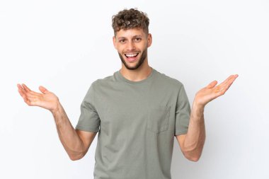 Young caucasian handsome man isolated on white background with shocked facial expression