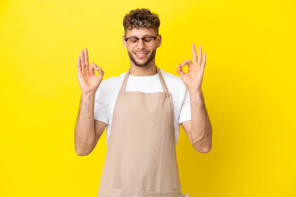 Restaurant Waiter Blonde Man Isolated Yellow Background Zen Pose — Zdjęcie stockowe