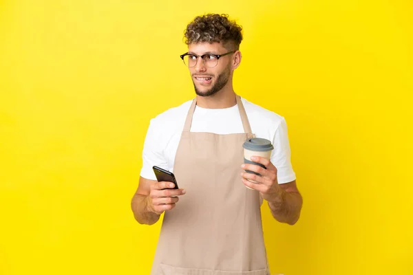 Restaurant Waiter Blonde Man Isolated Yellow Background Holding Coffee Take — Stockfoto