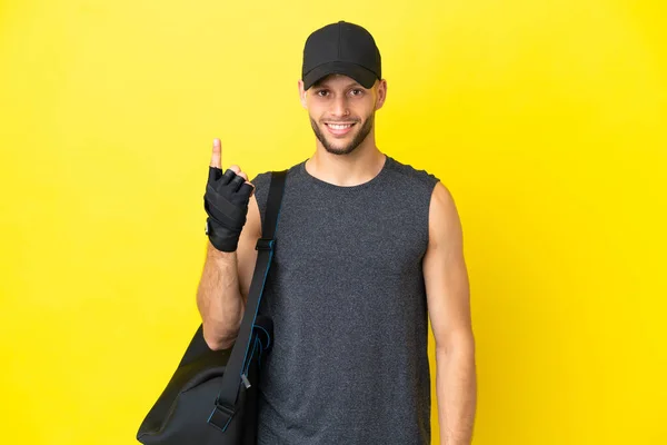 Young Sport Blonde Man Sport Bag Isolated Yellow Background Pointing — 图库照片
