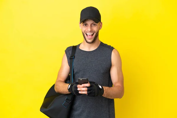 Young Sport Blonde Man Sport Bag Isolated Yellow Background Surprised — 图库照片