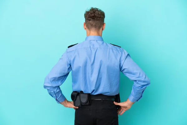 Young Police Blonde Man Isolated White Blue Background Back Position — 图库照片