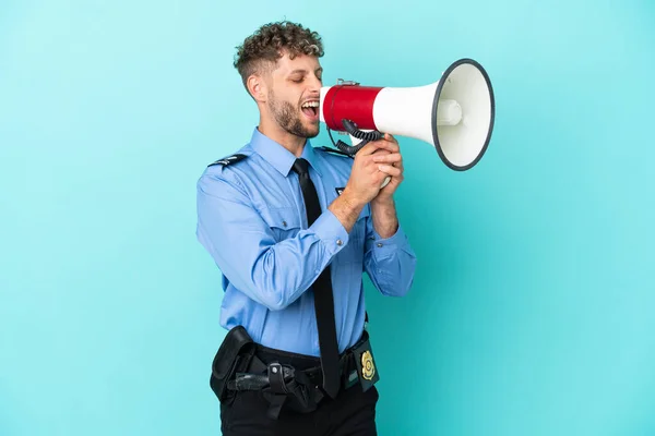Young police blonde man isolated white on blue background shouting through a megaphone