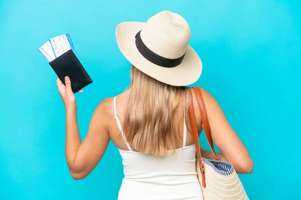 Young Caucasian Woman Swimsuit Holding Passport Isolated Blue Background Back — Stock fotografie