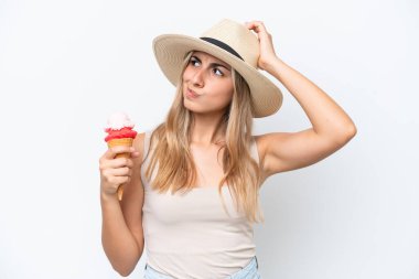 Young caucasian woman with a cornet ice cream isolated on white background having doubts and with confuse face expression