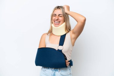 Woman with broken arm and wearing a sling isolated on white background smiling a lot