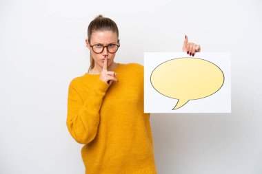 Young caucasian woman isolated on white background holding a placard with speech bubble icon doing silence gesture