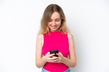 Blonde English young girl isolated on white background sending a message with the mobile