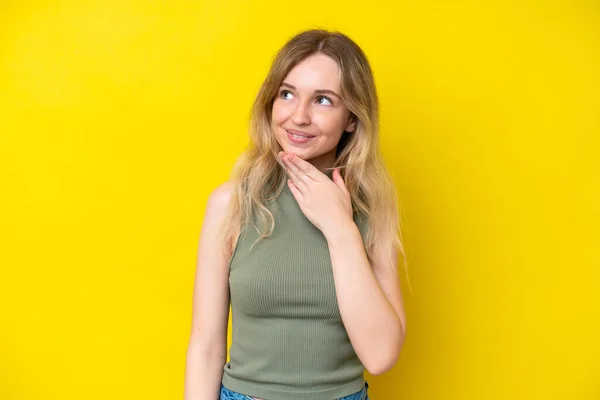 Blonde English Young Girl Isolated Yellow Background Looking While Smiling — Stockfoto