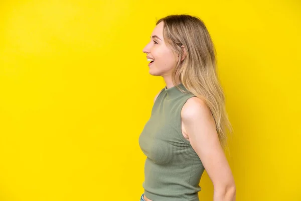 Blonde English Young Girl Isolated Yellow Background Laughing Lateral Position — Fotografie, imagine de stoc