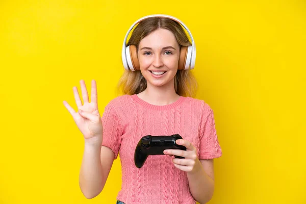Blonde English Young Girl Playing Video Game Controller Isolated Yellow — Stockfoto