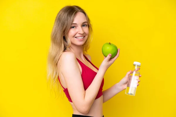 Blonde English Young Girl Isolated Yellow Background Apple Bottle Water — Fotografia de Stock