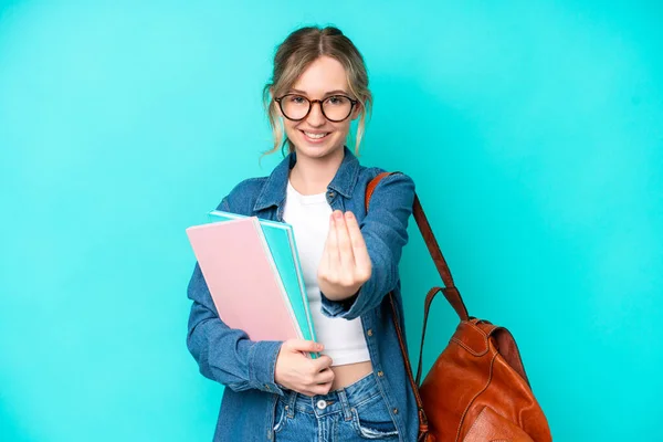 Young student woman isolated on blue background making money gesture