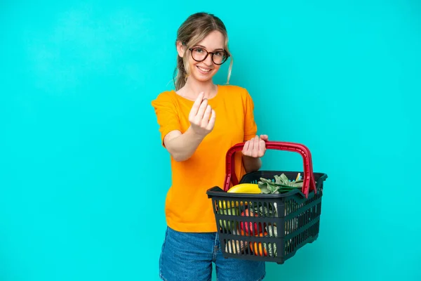 Blonde English Young Girl Holding Shopping Basket Full Food Isolated — Stockfoto