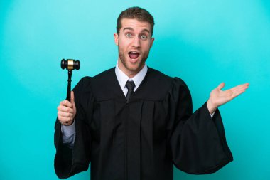 Judge caucasian man isolated on blue background with shocked facial expression