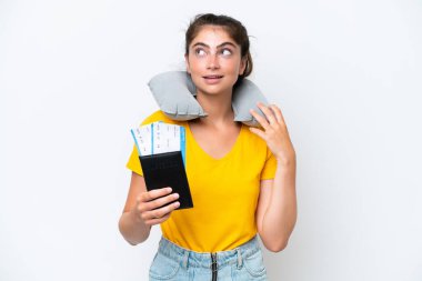 Young caucasian woman with Inflatable travel pillowisolated on white background thinking an idea while looking up 