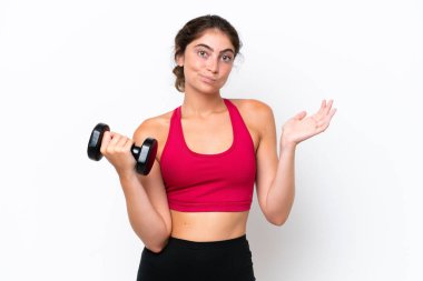 Young sport caucasian woman making weightlifting isolated on white background having doubts while raising hands