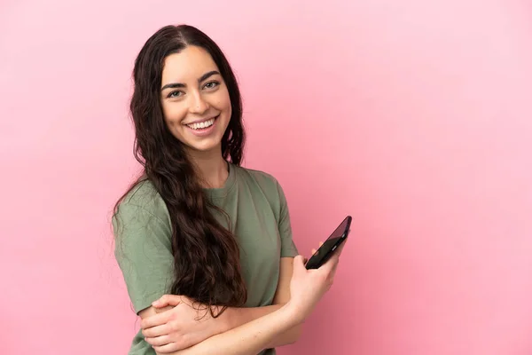 Young Caucasian Woman Isolated Pink Background Holding Mobile Phone Arms — Foto de Stock