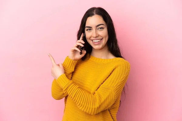 Young Caucasian Woman Using Mobile Phone Isolated Pink Background Pointing —  Fotos de Stock